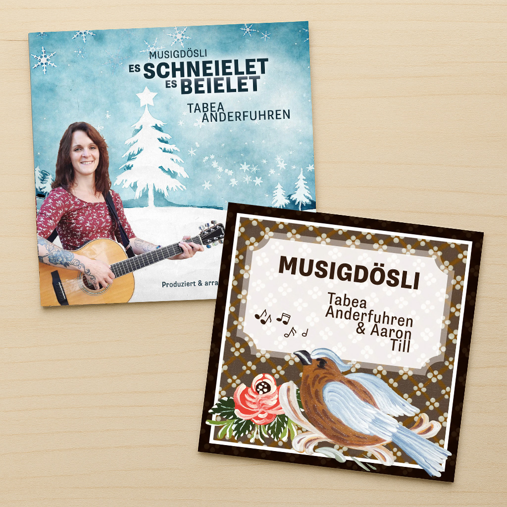 Die beiden CD-Versionen der Alben «Musigdösli und «Es schneielet, es beielet» liegen gefächert über einander.